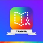 The Book Creator Trainer badge, featuring the Book Creator logo—a colorful square with a dotted book outline and a pair of scissors symbol—on a gradient blue and purple background. The word 'TRAINER' is displayed on a white ribbon at the bottom of the logo.