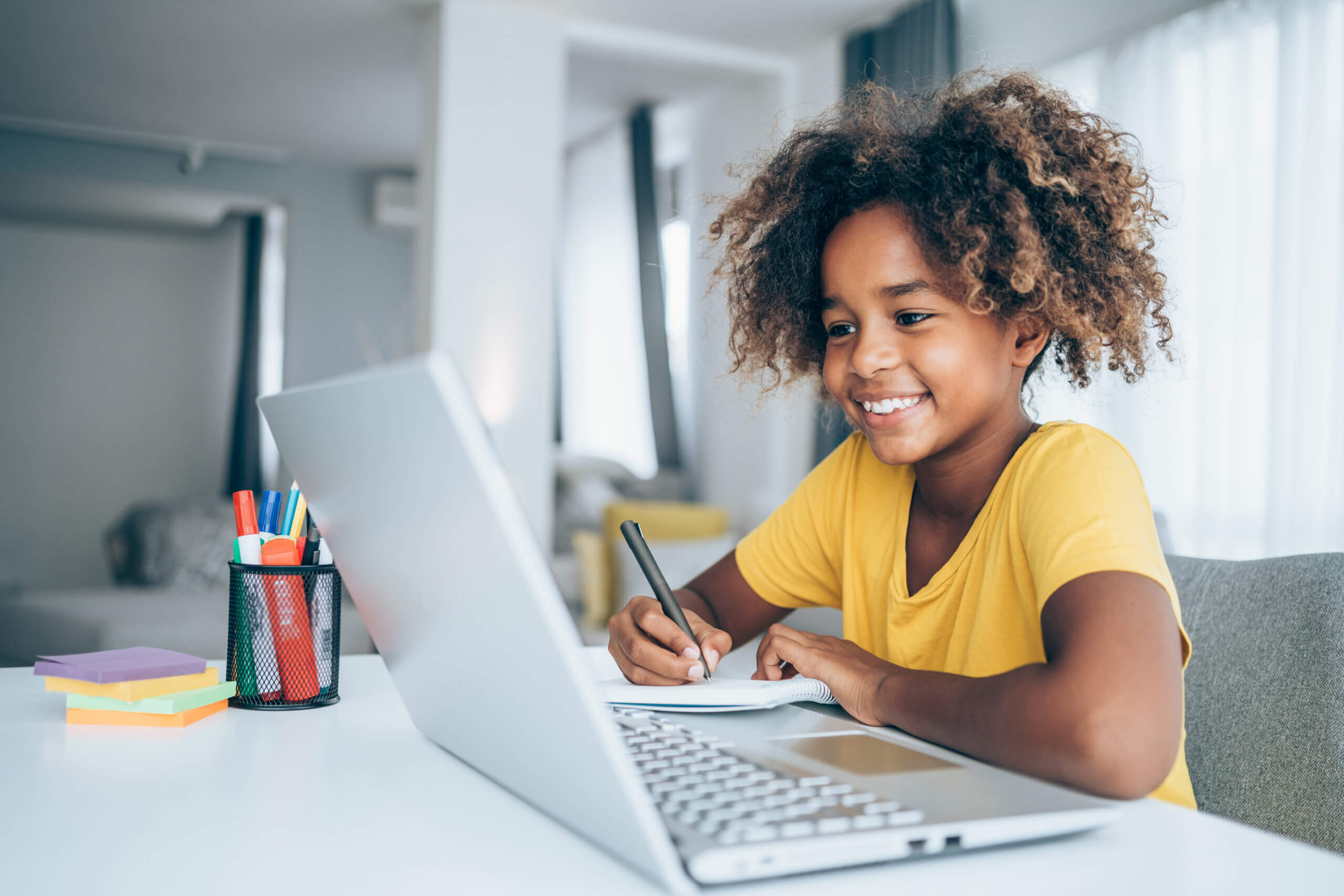 Schoolgirl studying with video online lesson at home.